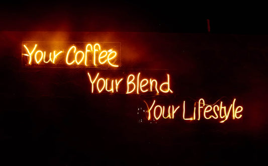 Glowing neon sign saying 'Your Coffee, Your Blend, Your Lifestyle' in warm tones, perfect for cafes.